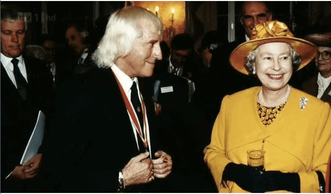 Jimmy Saville with the Queen of England